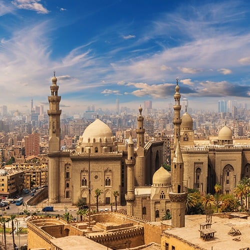 A panoramic view of Cairo Egypt featuring the Mosque-Madrasa of Sultan Hassan and other historic Islamic architecture