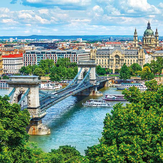 A panoramic view of Budapest Hungary featuring the iconic Széchenyi Chain Bridge spanning the Danube River