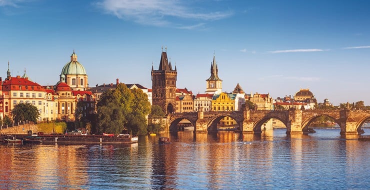 A panoramic view of Prague, Czech Republic, featuring the iconic Charles Bridge and the historic Old Town