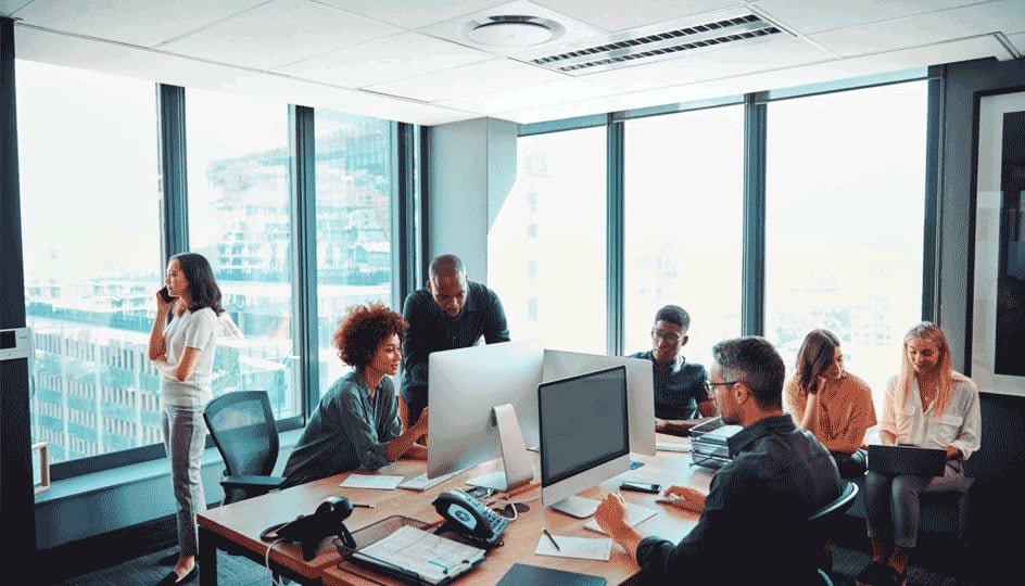 Colleagues working together in a busy casual office room